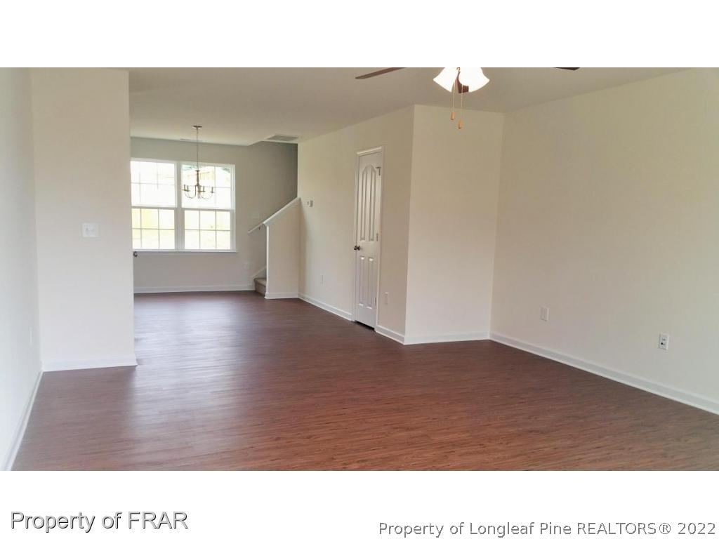 12 River Oak Street Spring Lake, NC 28390 - Photo 3 of 34 a room with a window and wooden floor