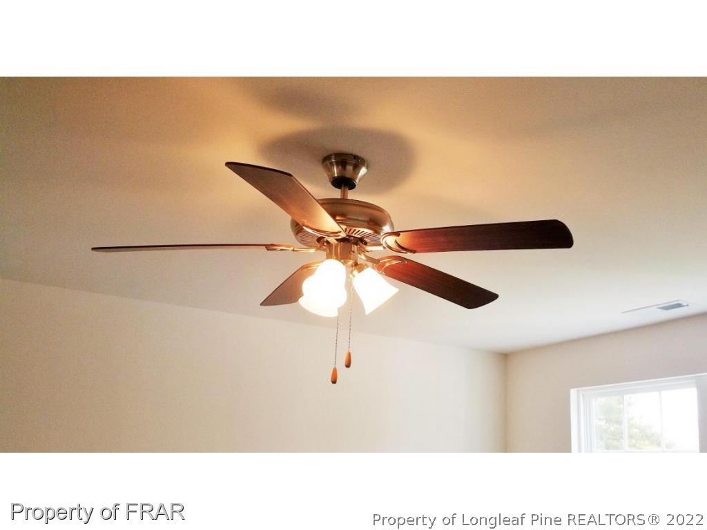 12 River Oak Street Spring Lake, NC 28390 - Photo 5 of 34 a picture of a room with a ceiling fan