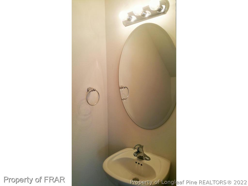 12 River Oak Street Spring Lake, NC 28390 - Photo 6 of 34 a bathroom with a sink and mirror