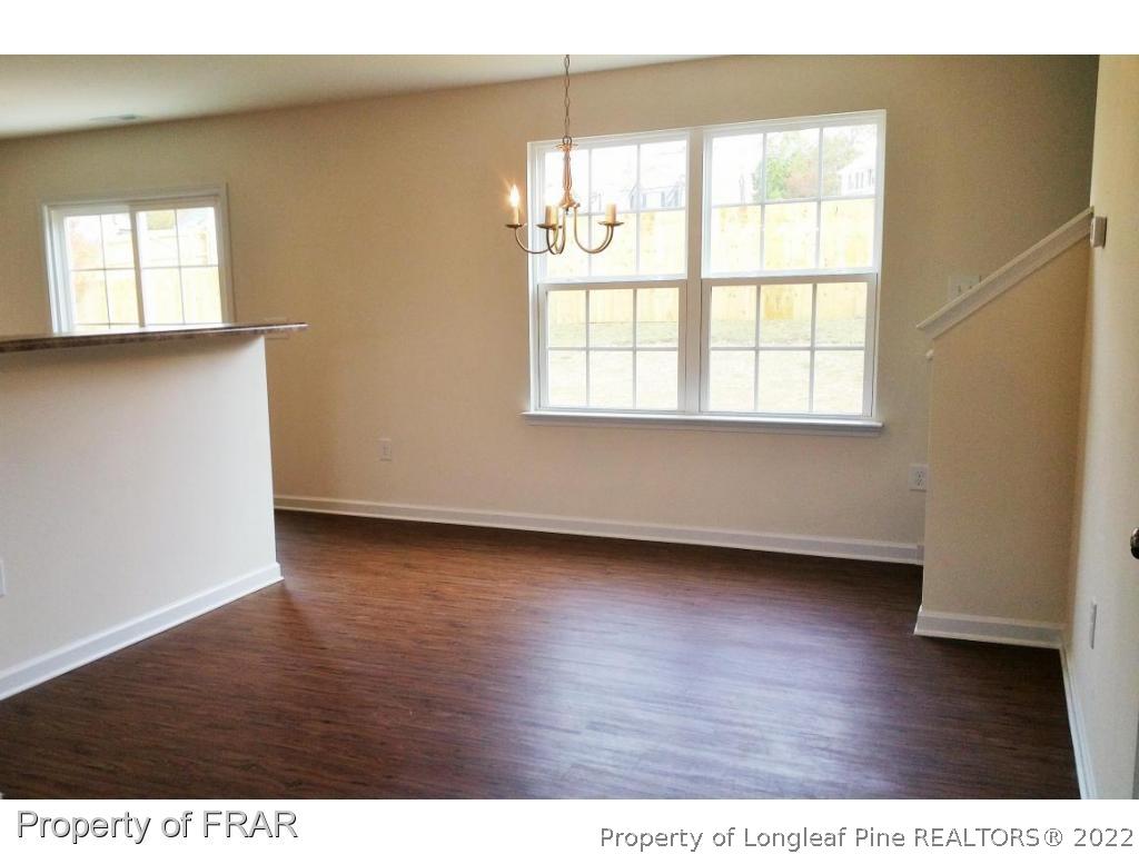 12 River Oak Street Spring Lake, NC 28390 - Photo 7 of 34 a view of an empty room with wooden floor and a window