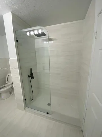 a bathroom with a sink a mirror and shower