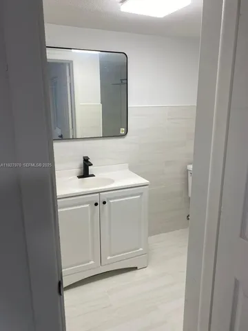 a bathroom with a sink and mirror