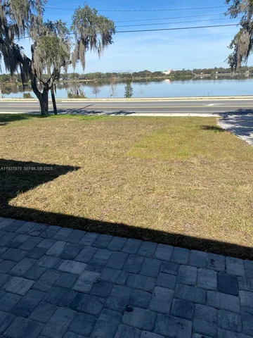 a view of swimming pool with outdoor seating and plants