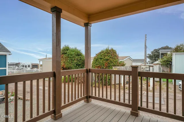 a view of a balcony with wooden floor