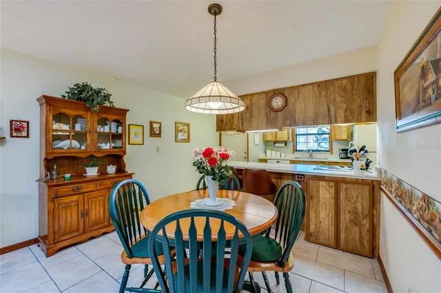a dining room filled chandelier and wooden floor