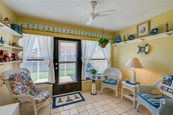 a living room with furniture and a floor to ceiling window