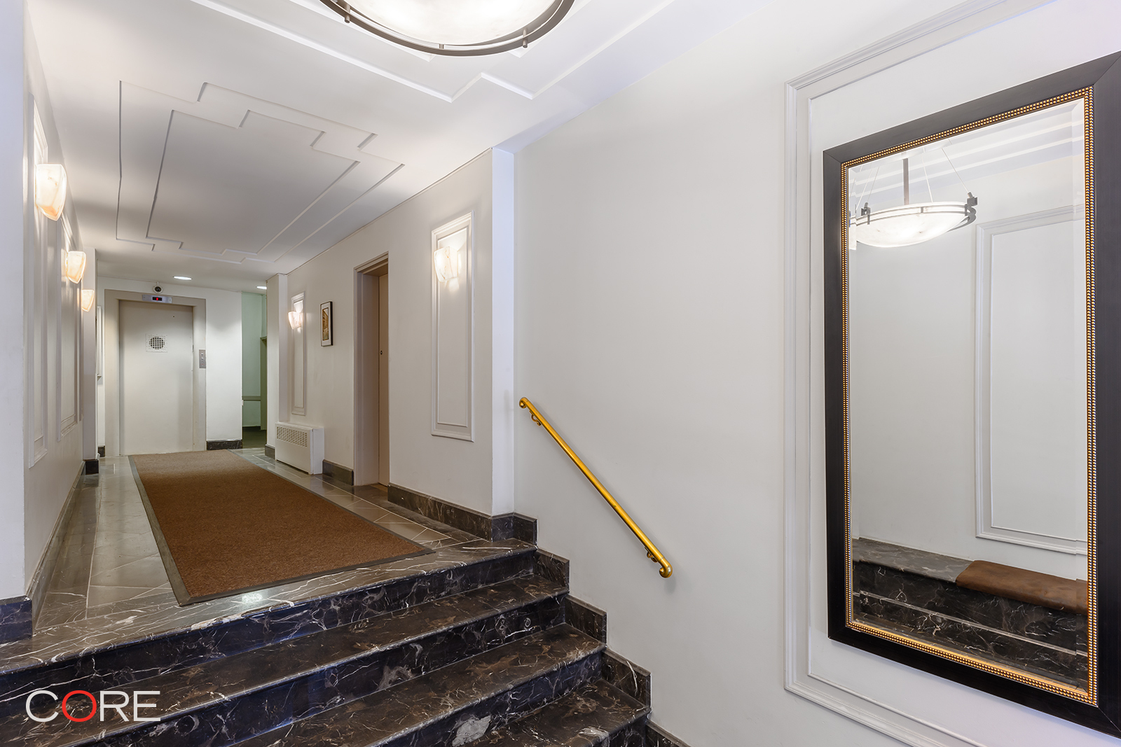 415 East 80th Street, Unit 5S Manhattan, NY 10075 - Photo 7 of 10 a view of a hallway with wooden floor and staircase