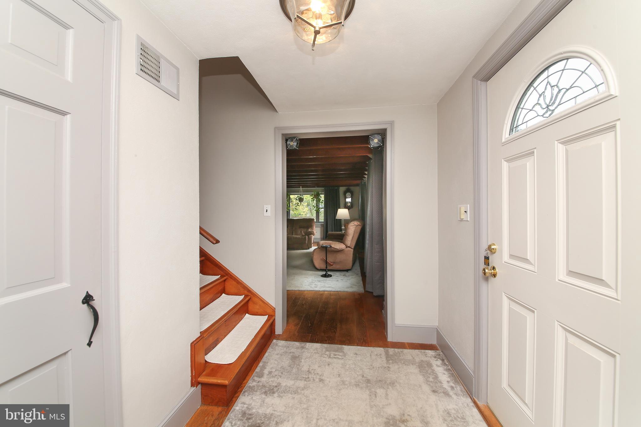 150 Edison Furlong Road Doylestown, PA 18901 - Photo 13 of 36 a view of a hallway to a bedroom with wooden floor and a front door