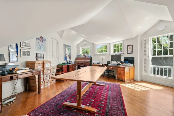 a living room with furniture a rug and a projector