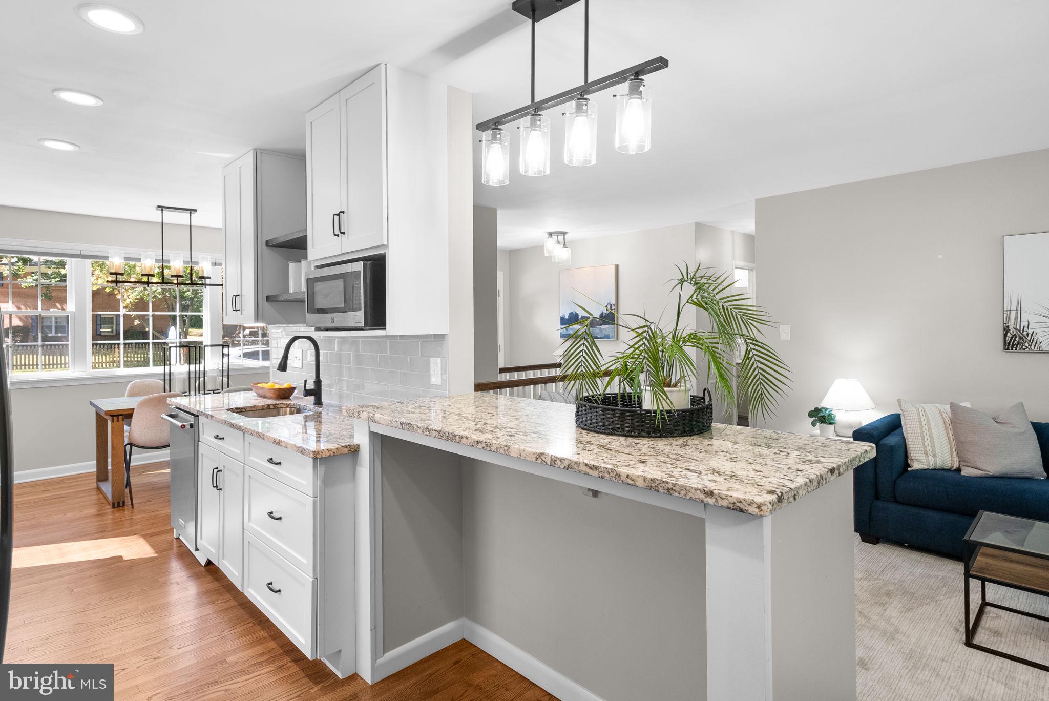 9907 Big Rock Road Silver Spring, MD 20901 - Photo 11 of 45 a kitchen with stainless steel appliances granite countertop a sink stove and refrigerator