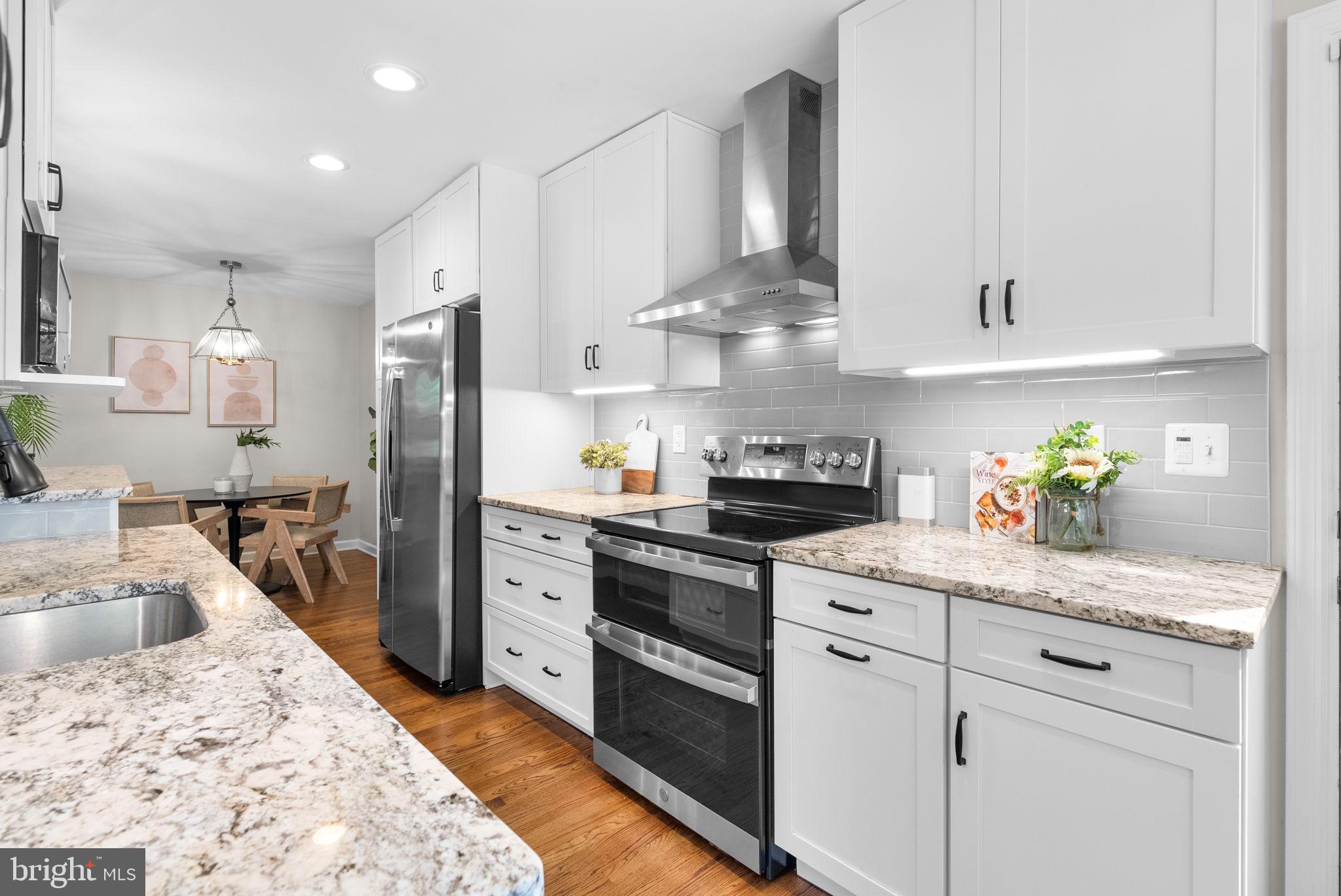 9907 Big Rock Road Silver Spring, MD 20901 - Photo 13 of 45 a kitchen with white cabinets and appliances