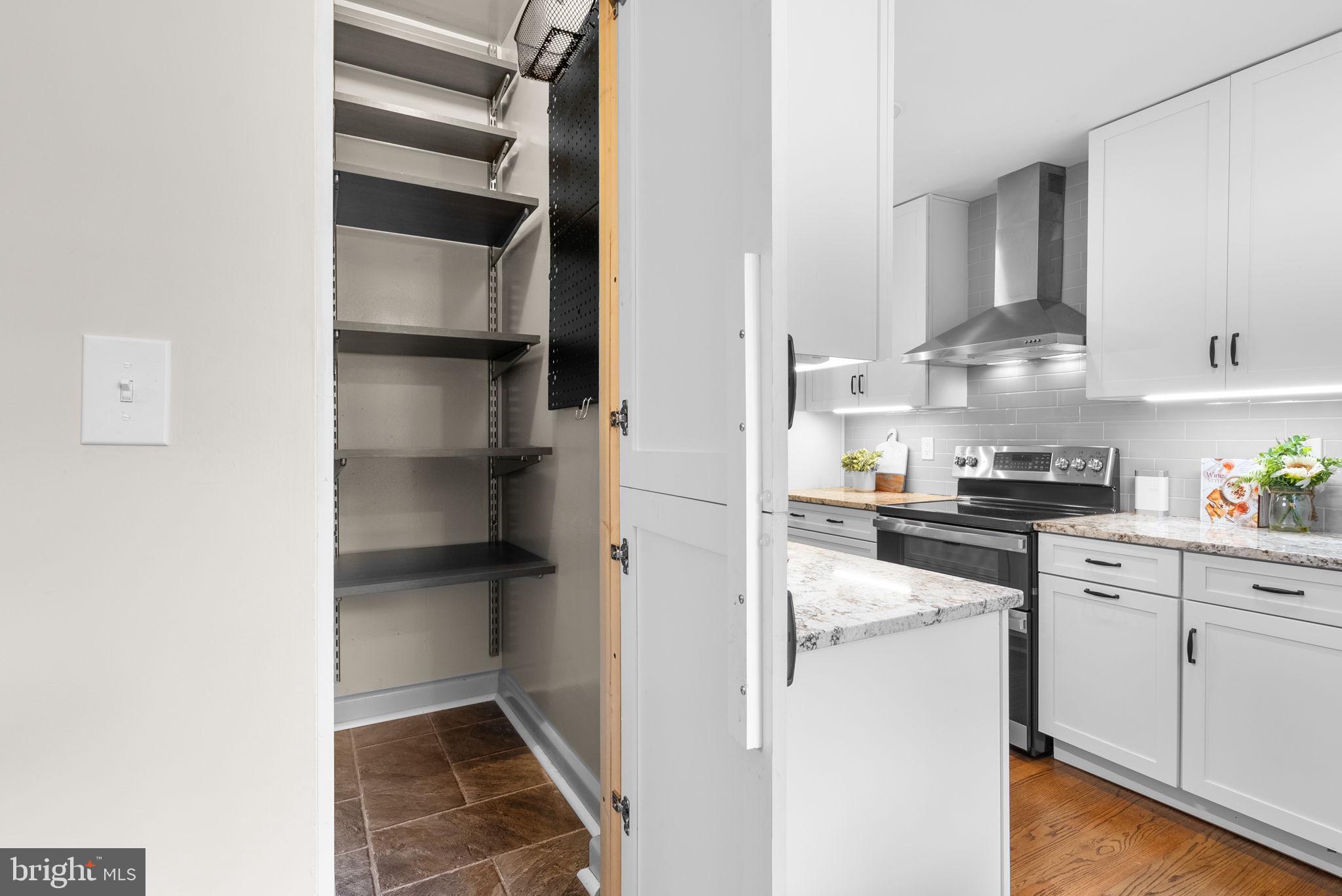 9907 Big Rock Road Silver Spring, MD 20901 - Photo 14 of 45 a kitchen with cabinets and appliances