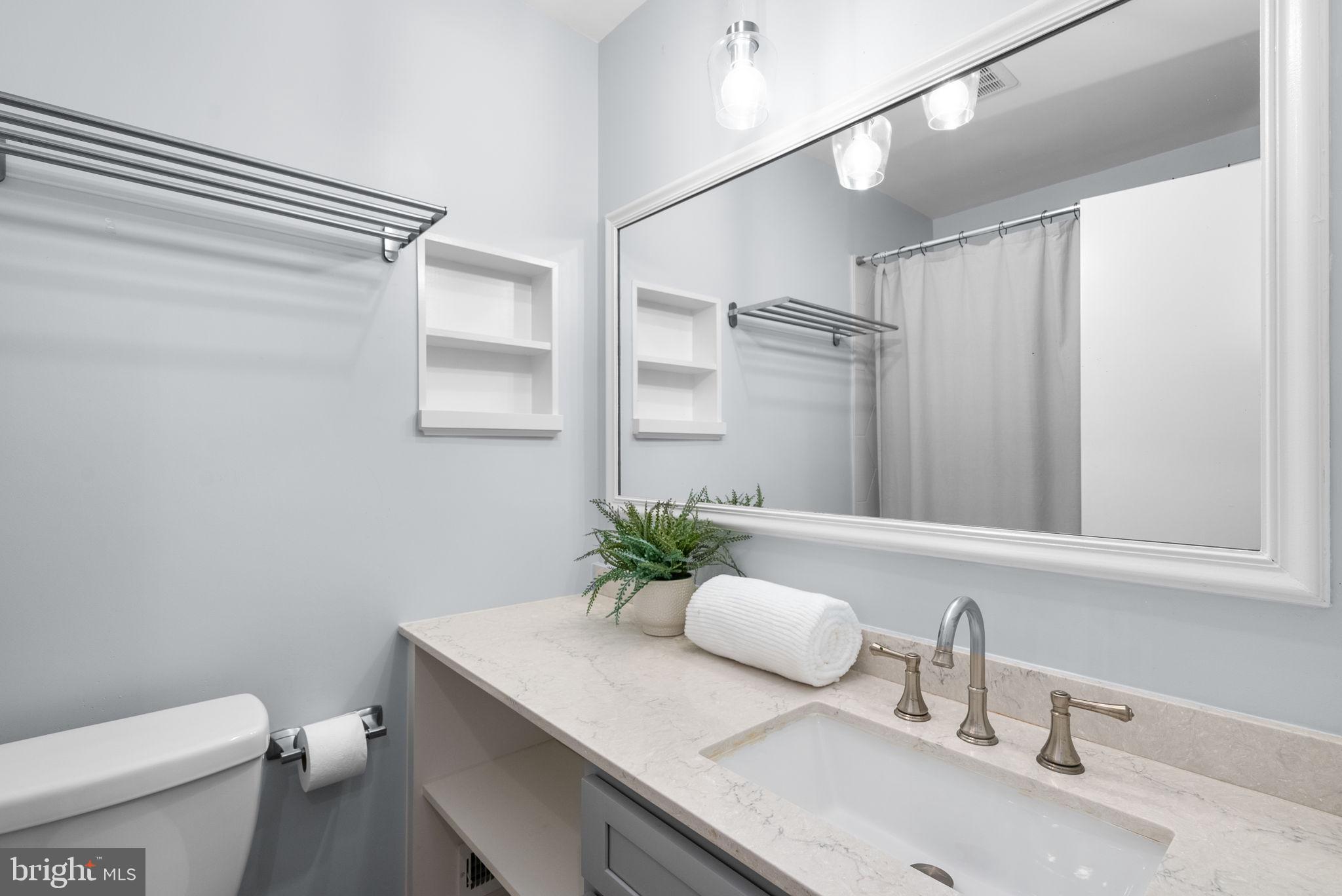 9907 Big Rock Road Silver Spring, MD 20901 - Photo 18 of 45 a bathroom with a sink a toilet and mirror