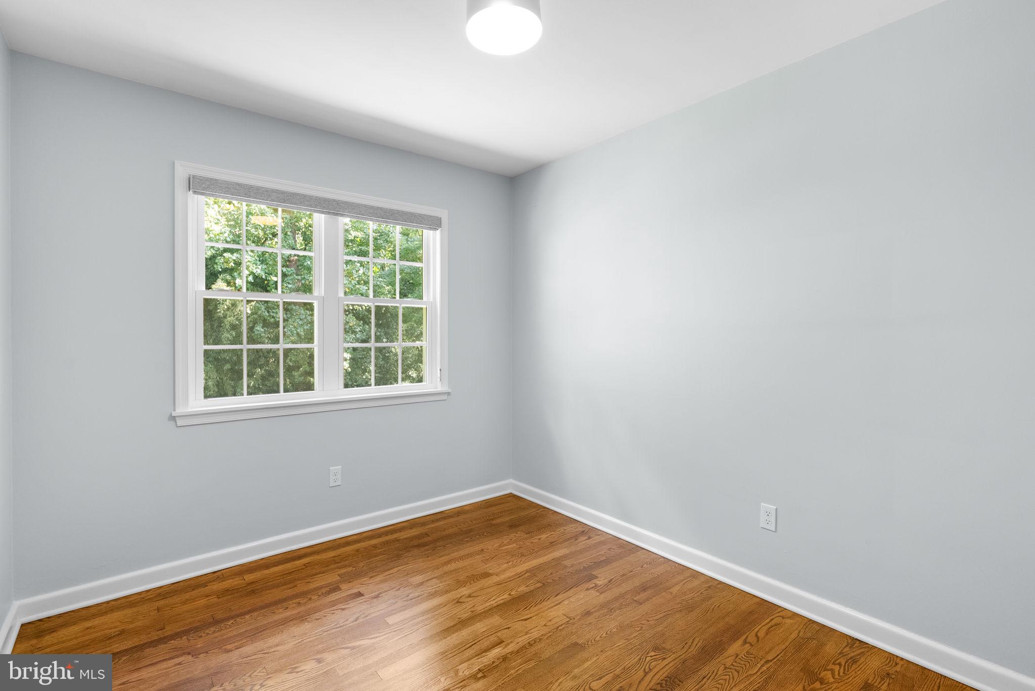 9907 Big Rock Road Silver Spring, MD 20901 - Photo 19 of 45 an empty room with wooden floor and windows