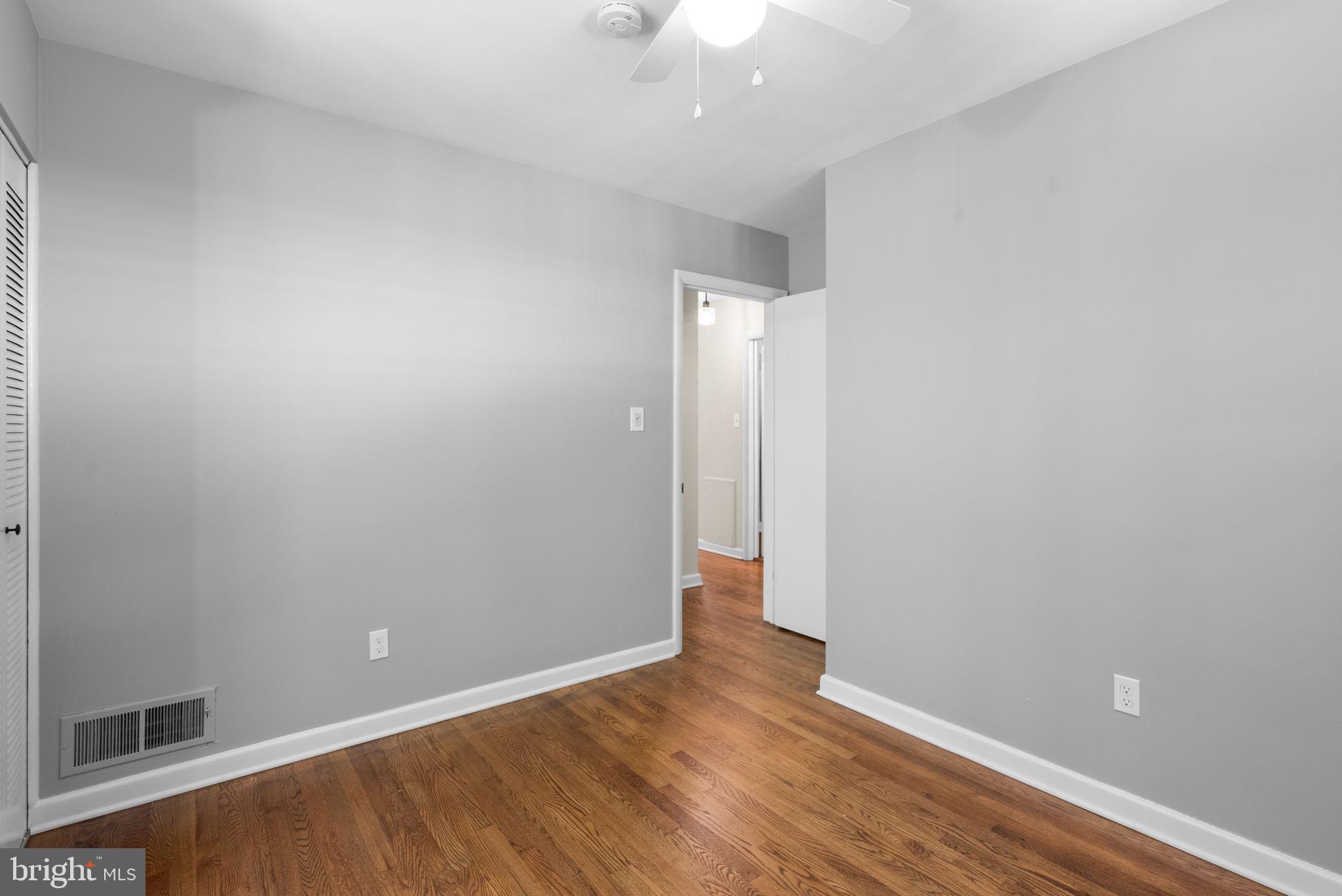 9907 Big Rock Road Silver Spring, MD 20901 - Photo 22 of 45 a view of an empty room with wooden floor