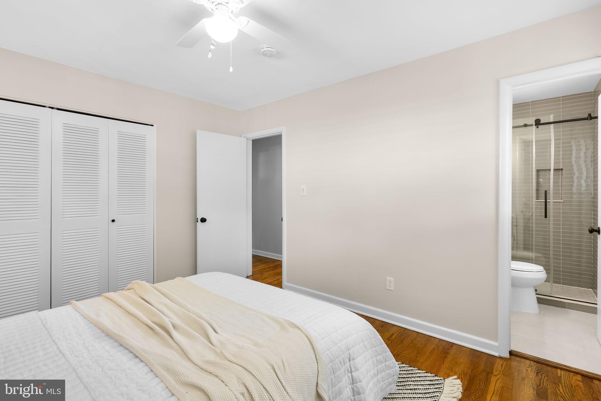 9907 Big Rock Road Silver Spring, MD 20901 - Photo 24 of 45 a bedroom with a bed and a chandelier