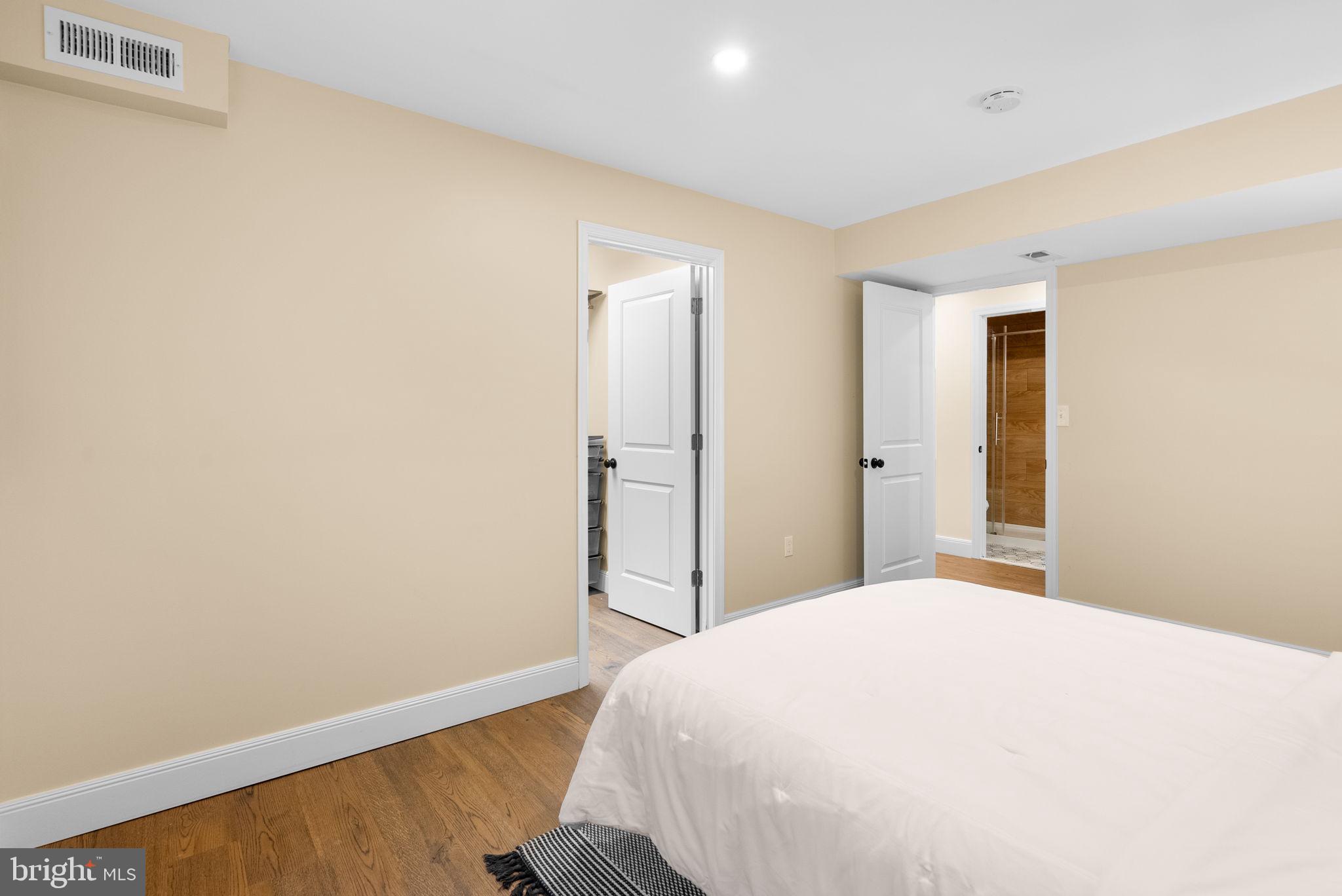 9907 Big Rock Road Silver Spring, MD 20901 - Photo 36 of 45 a bedroom with a bed and wooden floor