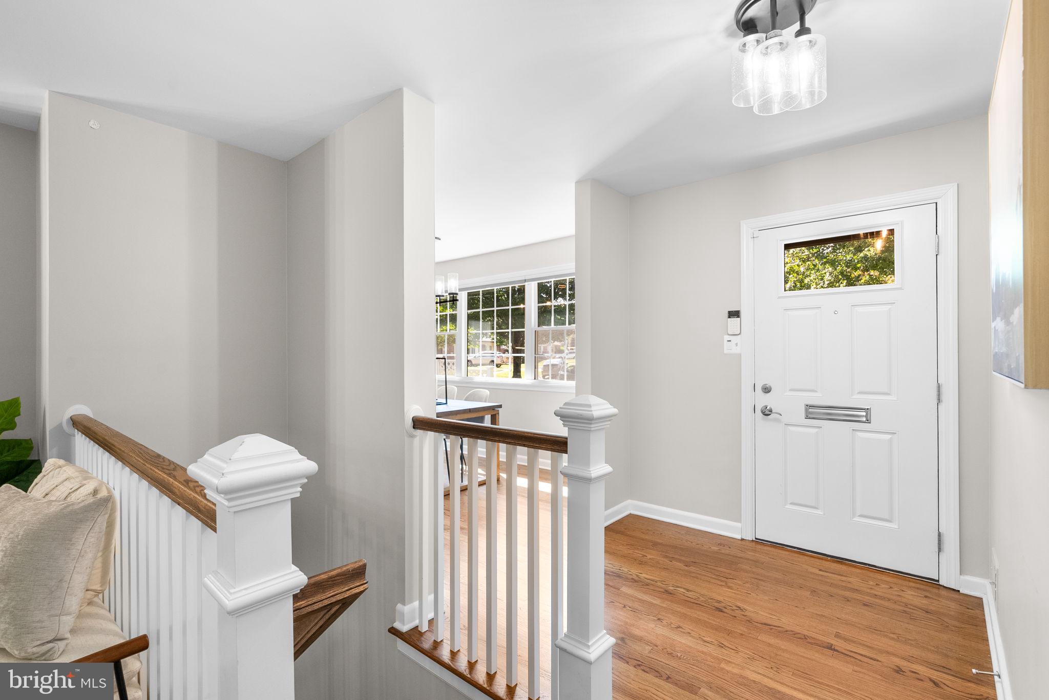 9907 Big Rock Road Silver Spring, MD 20901 - Photo 4 of 45 a view of a hallway with entryway wooden floor and windows