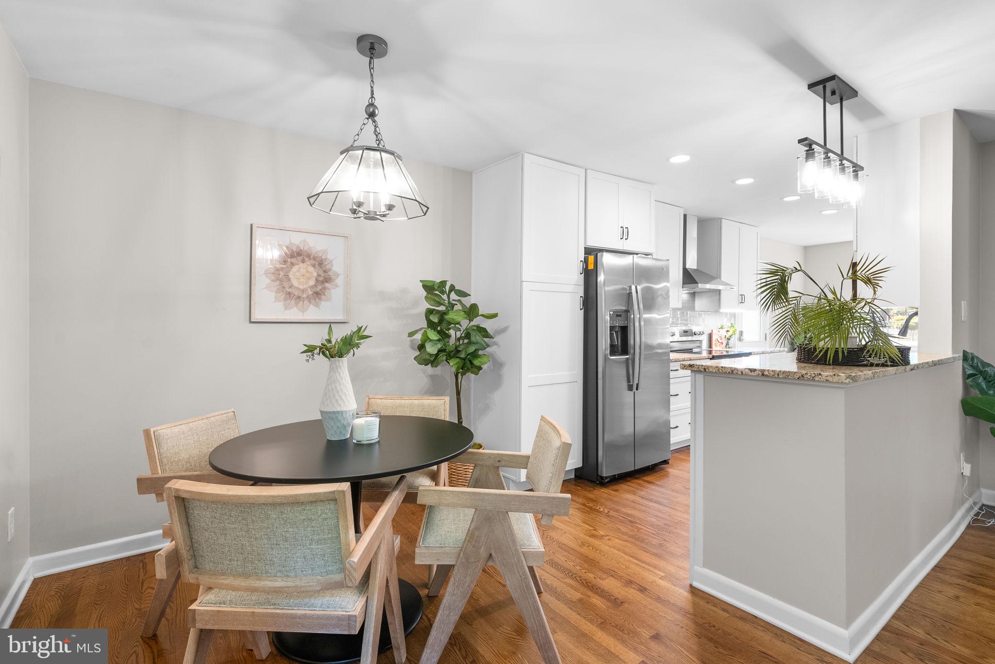9907 Big Rock Road Silver Spring, MD 20901 - Photo 8 of 45 a dining room with furniture a chandelier and wooden floor