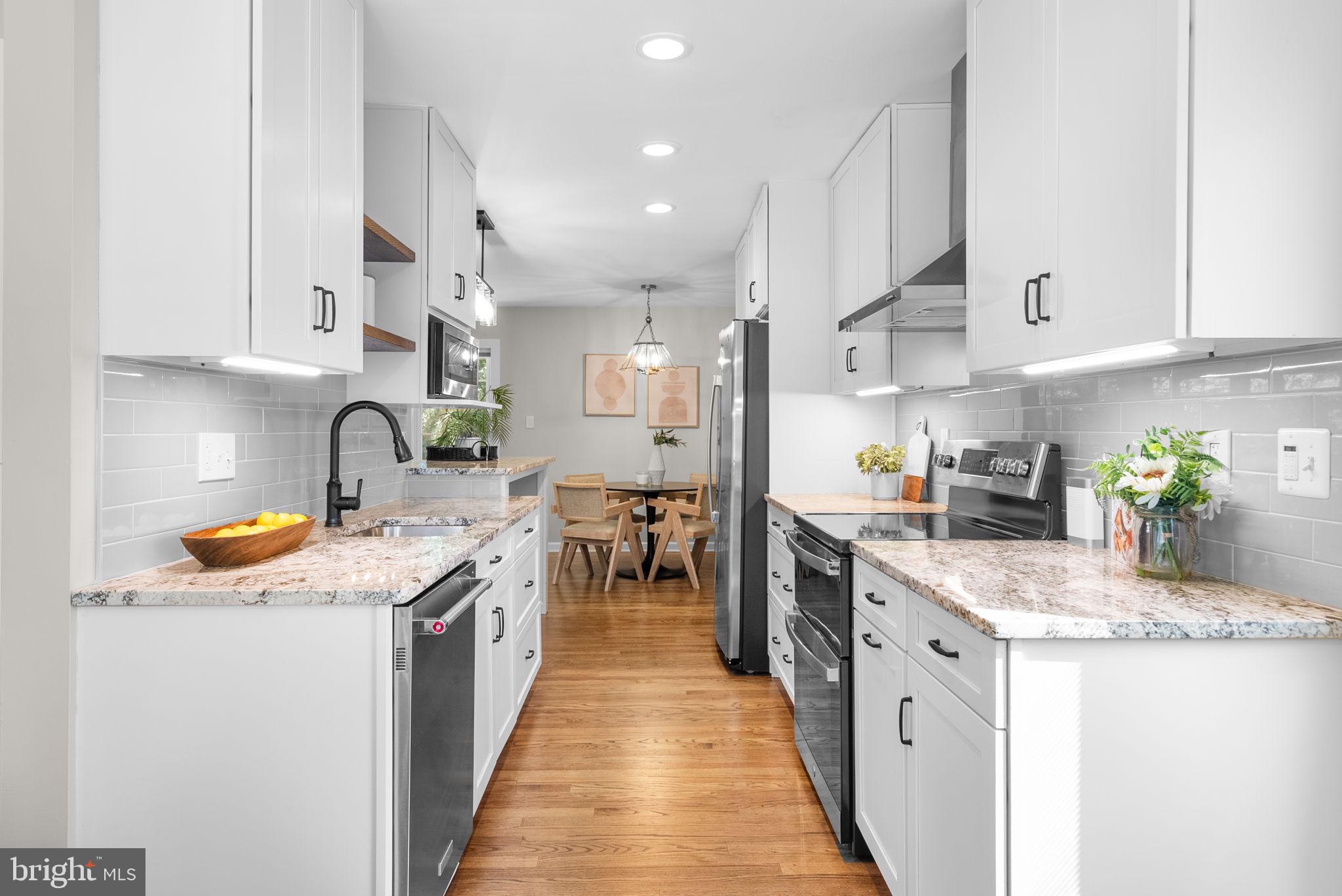 9907 Big Rock Road Silver Spring, MD 20901 - Photo 10 of 45 a kitchen with stainless steel appliances granite countertop lots of counter top space sink stove and cabinets