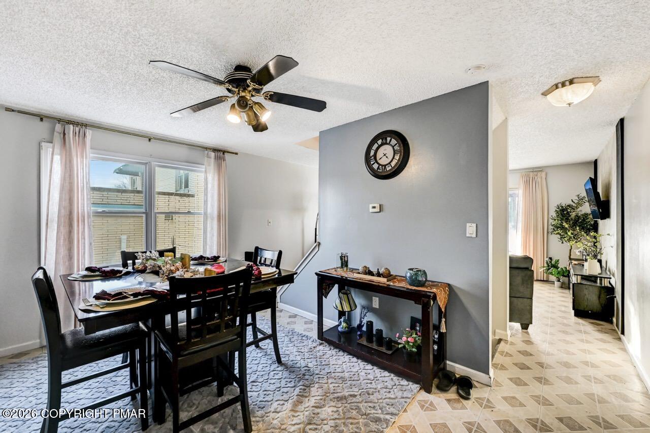 844 South Front Street Allentown, PA 18103 - Photo 16 of 45 a view of a dining room and livingroom with furniture wooden floor a rug and a chandelier