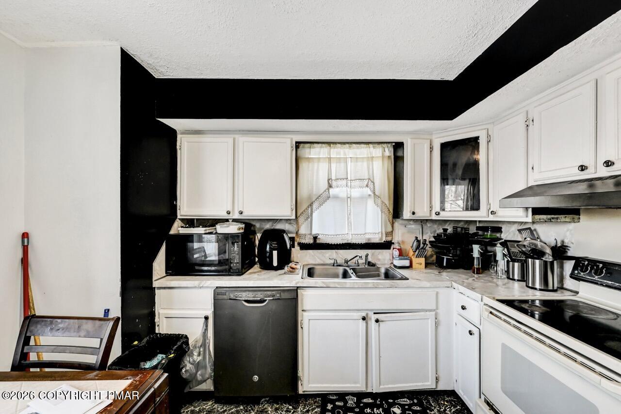 844 South Front Street Allentown, PA 18103 - Photo 22 of 45 a kitchen with a sink a stove and cabinets