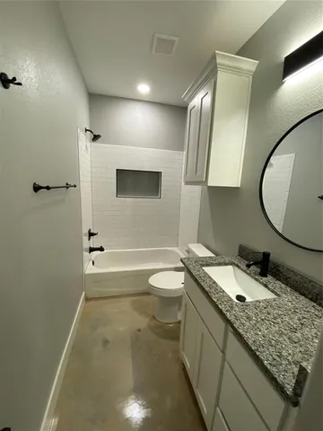 a bathroom with a sink a toilet and mirror