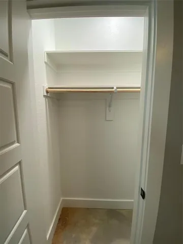a bathroom with a granite countertop sink mirror vanity and toilet