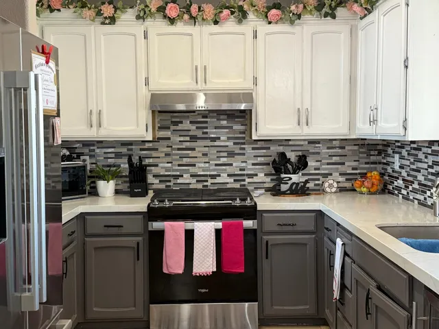 a kitchen with stainless steel appliances granite countertop a stove a sink and a microwave