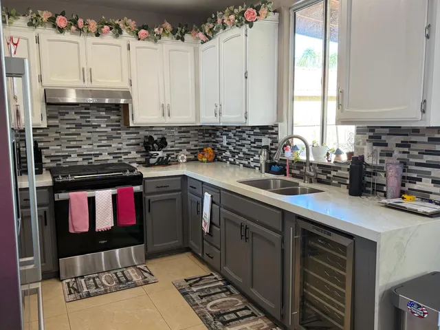 a kitchen with a sink stove and cabinets