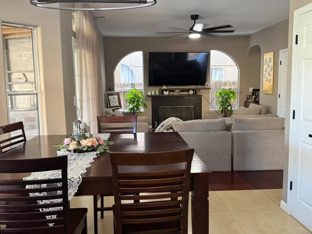 a living room with fireplace a flat screen tv and a window
