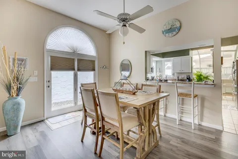 a kitchen with a white stove top oven and white cabinets