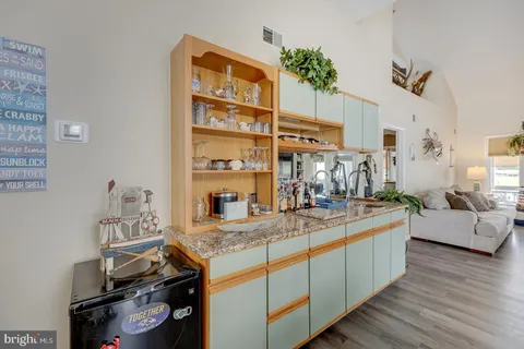a kitchen with granite countertop a refrigerator and a sink