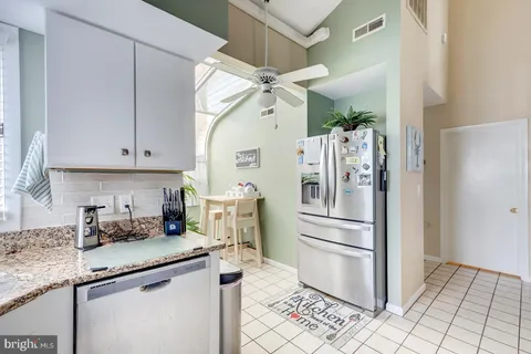 a living room with furniture and large windows