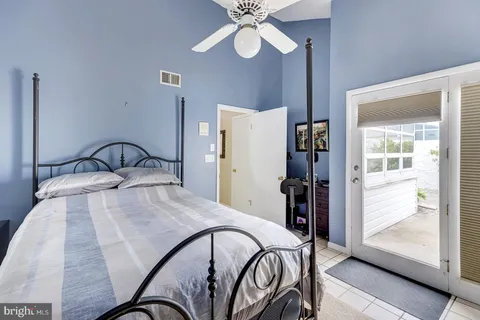 a en suite spacious bedroom with a bed and a couch