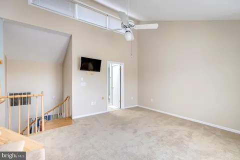 a view of a house with a yard and potted plants