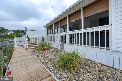 a view of a dining room with furniture and a potted plant