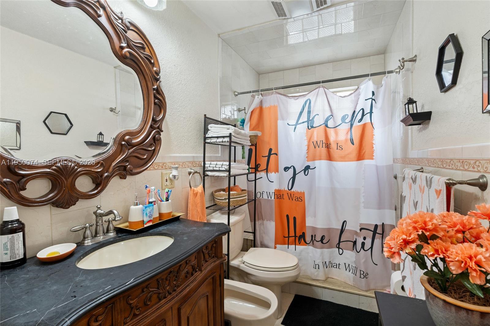 5951 Southwest 4th Street Miami, FL 33144 - Photo 14 of 23 a bathroom with a sink vanity mirror and toilet