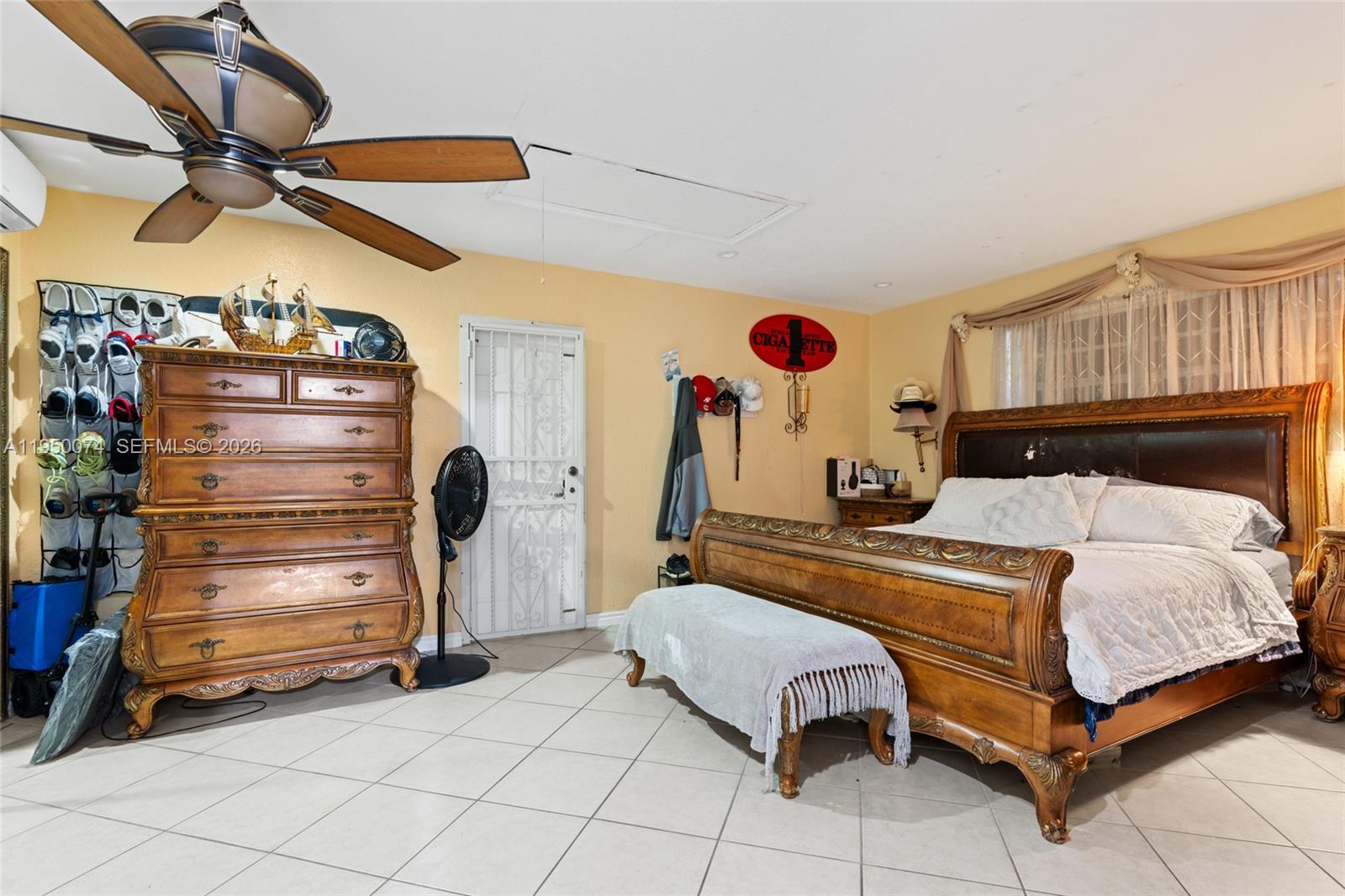 5951 Southwest 4th Street Miami, FL 33144 - Photo 16 of 23 a bedroom with a bed and a chandelier
