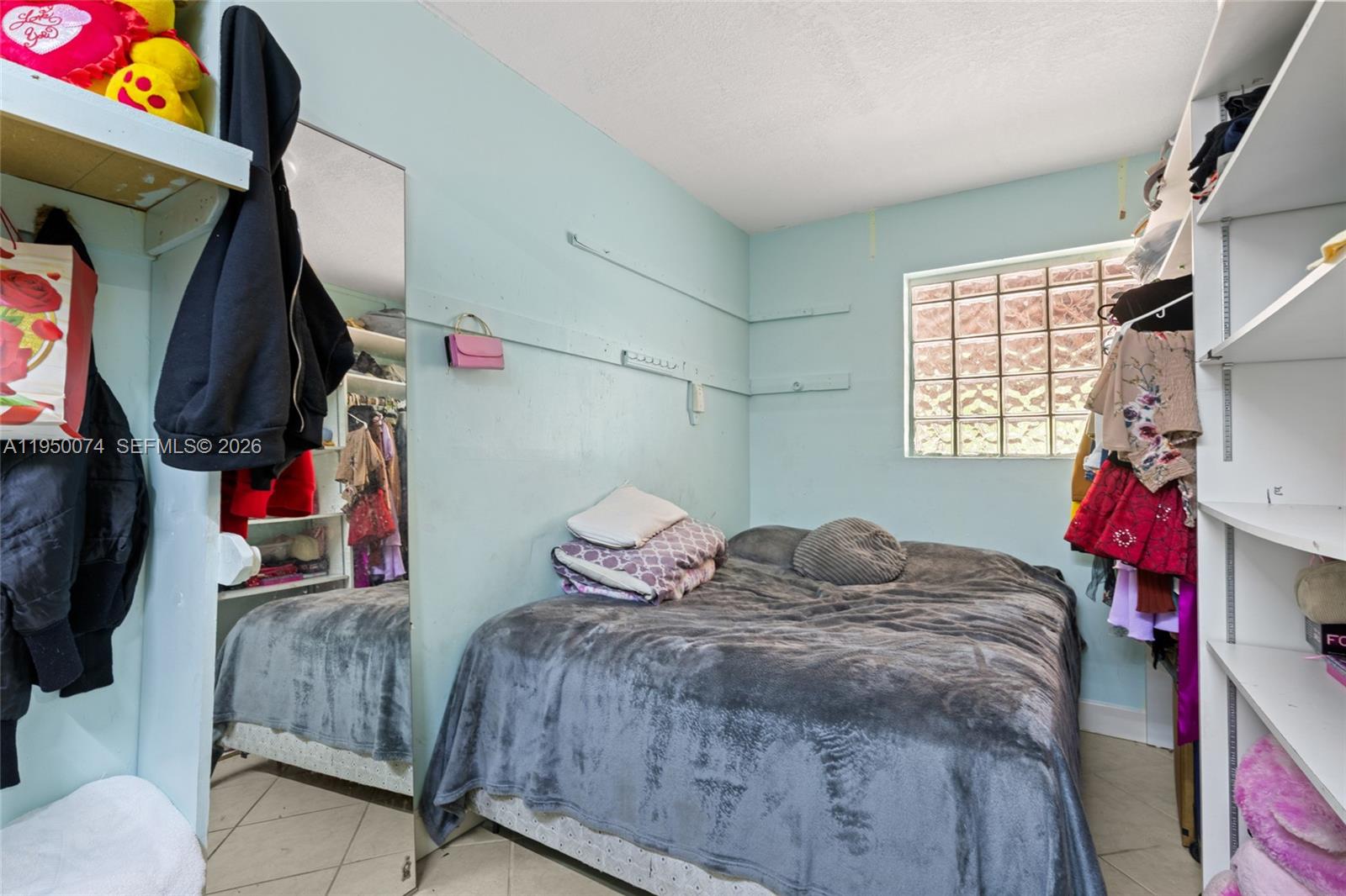 5951 Southwest 4th Street Miami, FL 33144 - Photo 17 of 23 a bedroom with a bed and window