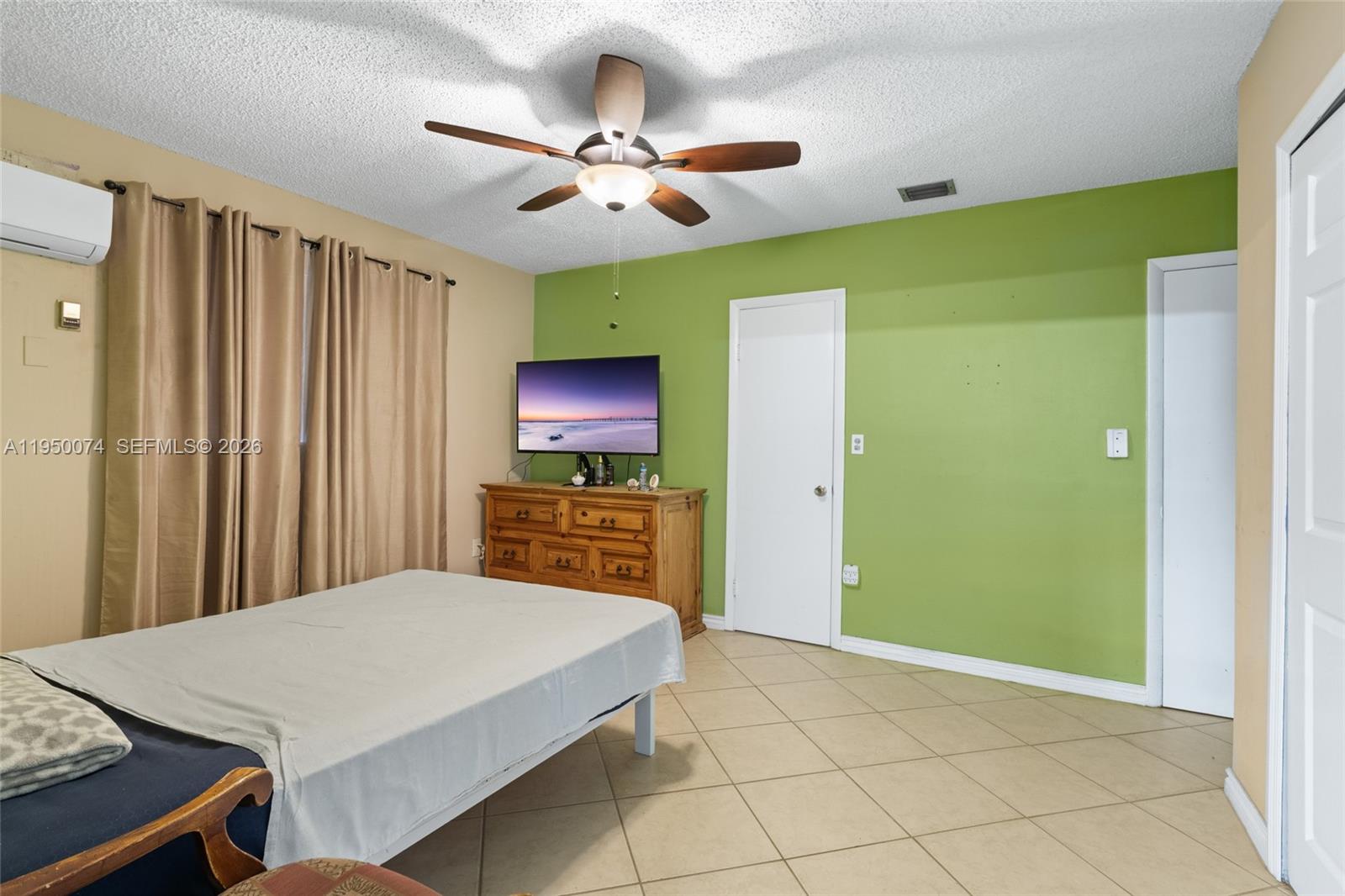 5951 Southwest 4th Street Miami, FL 33144 - Photo 6 of 23 a bedroom with a bed and a flat screen tv
