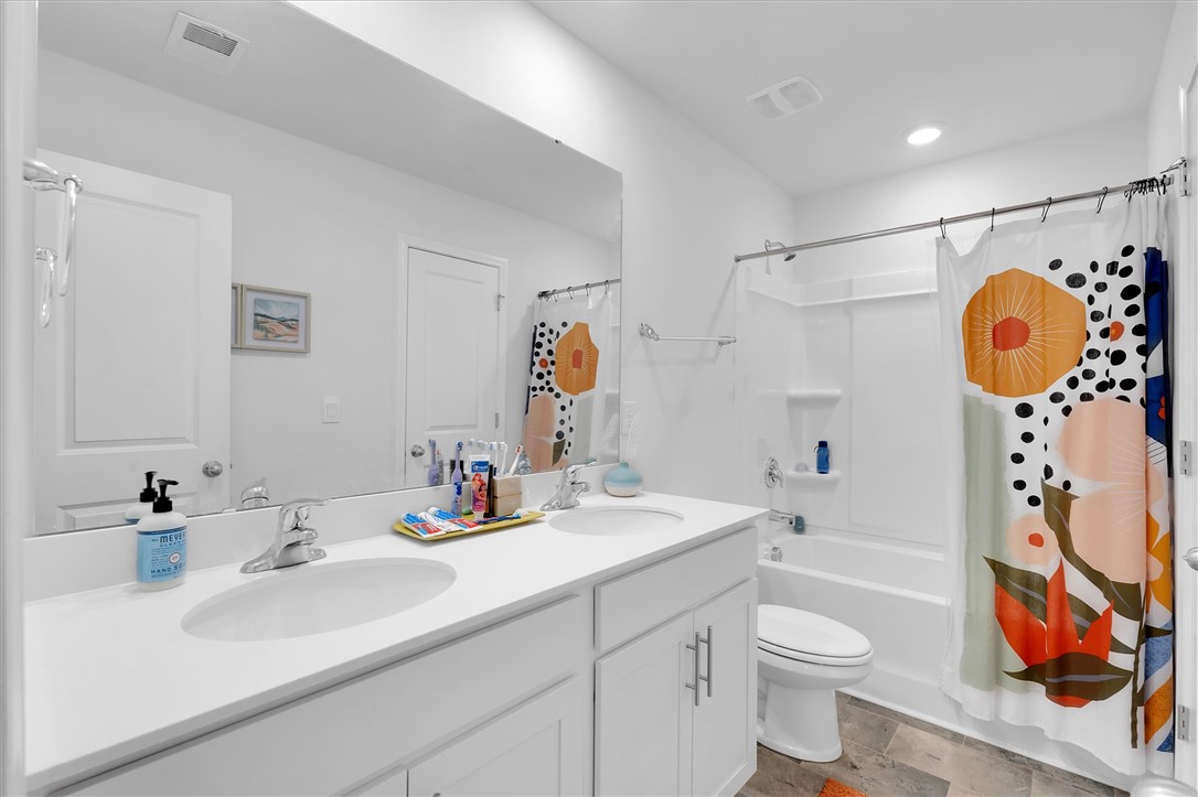 191 Light Spring Road Easley, SC 29642 - Photo 29 of 34 This bright bathroom features a dual vanity and a clean, modern aesthetic.
