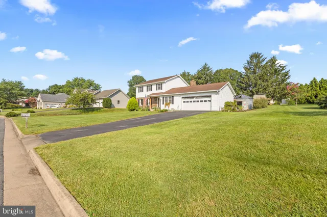 a front view of a house with a yard table and chairs