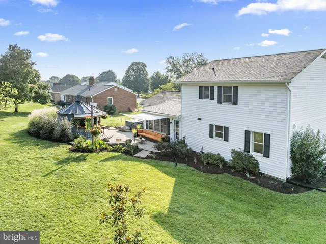 a front view of house with yard and trees