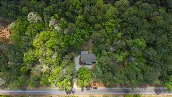 an aerial view of a house with a yard