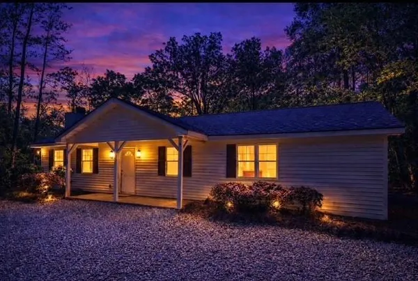 a view of a house with a yard and a tree