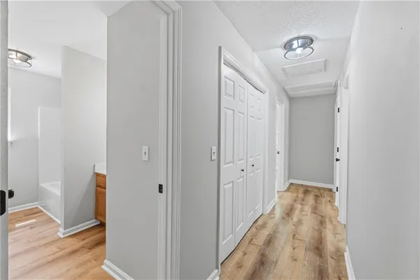 a view of a hallway with wooden floor