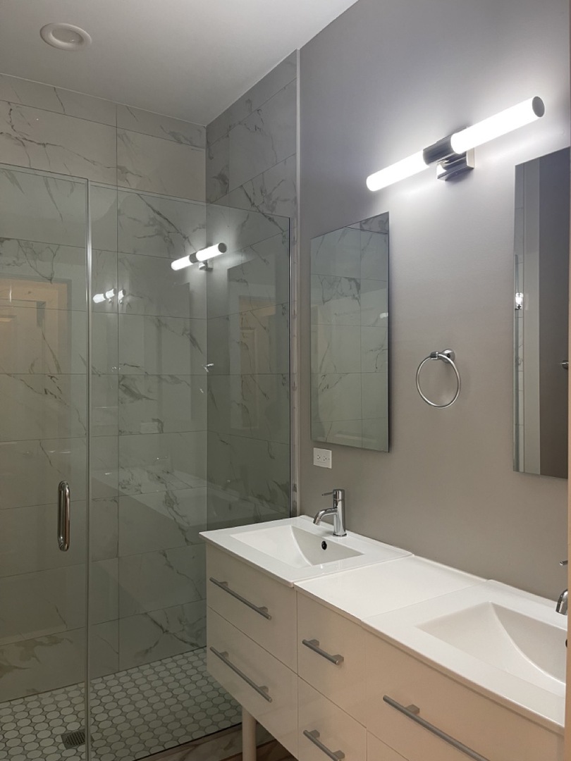 215 South Hamilton Avenue, Unit 1N Chicago, IL 60612 - Photo 12 of 23 a bathroom with a sink shower and a mirror