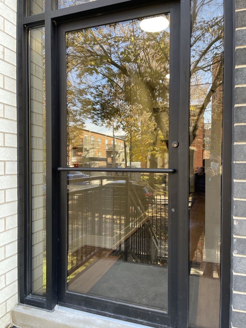 215 South Hamilton Avenue, Unit 1N Chicago, IL 60612 - Photo 2 of 23 a bathroom with a glass door