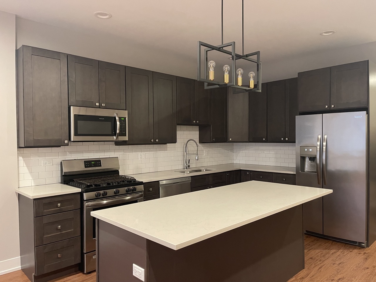 215 South Hamilton Avenue, Unit 1N Chicago, IL 60612 - Photo 4 of 23 a kitchen with stainless steel appliances a stove a sink and a refrigerator